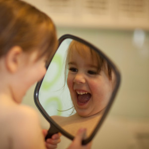 Baby looking in Mirror demonstrating What you put out is what you get back
