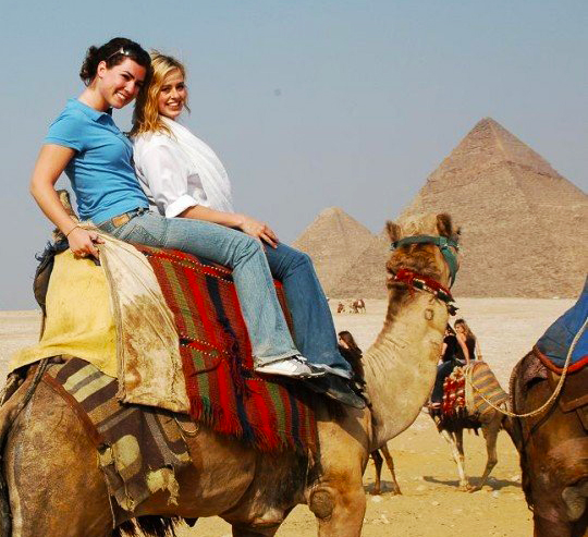 A travel picture of Bridget Nielsen on a camel in Egypt