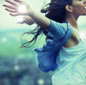 Woman soaring with arms thrown back demonstrating self empowerment