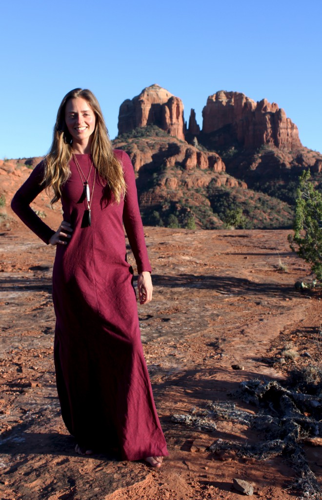 Girl in red dress in front of cathedral rock vortex in Sedona